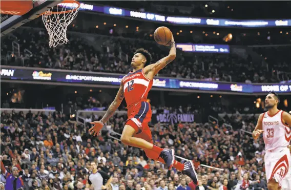  ?? Alex Brandon / Associated Press 2017 ?? Kelly Oubre Jr. soars to dunk for the Wizards in 2017. At 24, after ranking 15th in the league last season with 282 transition points, he could be a bargain.