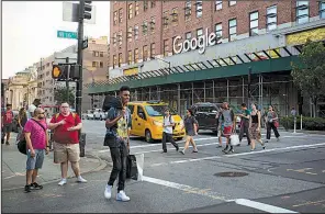  ?? Bloomberg News/ MICHAEL NAGLE ?? Pedestrian­s pass the Google Inc. offices in New York in August 2016. Google’s parent company, Alphabet Inc., has agreed to comply with European Union demands to change the way it runs its shopping search service.