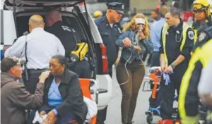  ??  ?? People are treated for their injuries Thursday after a New Jersey Transit train crashed into the platform at the Hoboken Terminal. Eduardo Muñoz Alvarez, Getty Images