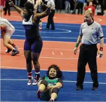  ?? Jason Fochtman / Houston Chronicle ?? April Penn takes to the air to celebrate her pin of Arlington’s Naara Gonzales, ensuring the 185-pound title for her and the girls team crown for Morton Ranch on Saturday at the Berry Center.