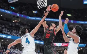  ?? JUSTIN FORD GETTY IMAGES FILE PHOTO ?? With their strong defence and up tempo offence, Reggie Chaney, middle, and the Houston Cougars are a good bet to win it all in this year’s March Madness tournament.