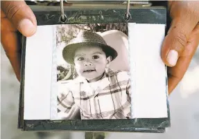  ?? LiPo Ching / Special to The Chronicle ?? Noe Romero, 36, of Madera, holds a photo of his 6yearold nephew, Stephen Romero, who was known for his manners, love of music and cologne.