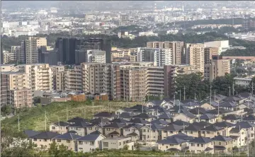  ??  ?? Residentia­l high-rise buildings and houses in Minoh, Osaka Prefecture.