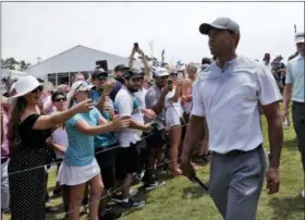  ?? LYNNE SLADKY — THE ASSOCIATED PRESS ?? Tiger Woods walks off the 18th hole during the third round of the Players Championsh­ip golf tournament, Saturday in Ponte Vedra Beach, Fla.