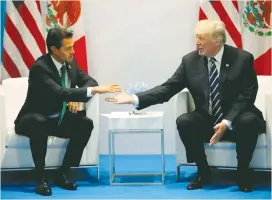  ?? (Carlos Barria/Reuters) ?? US PRESIDENT Donald Trump shakes hands with Mexico’s President Enrique Pena Nieto during their meeting at the G20 summit in Hamburg, Germany, earlier this month.