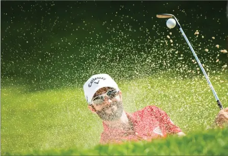  ?? The Associated Press ?? Adam Hadwin of Abbotsford blasts from a bunker on the ninth hole during the 2018 Canadian Open at Glen Abbey Golf Club in Oakville Ont.