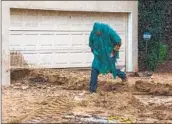  ?? Irfan Khan Los Angeles Times ?? A MAN navigates the storm-induced hillside runoff in front of his residence in Studio City on Jan. 10.