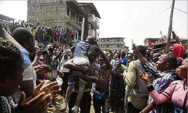  ??  ?? Lucky to be alive: A child being rescued from the rubble of the collapsed building in Lagos, Nigeria. — AP