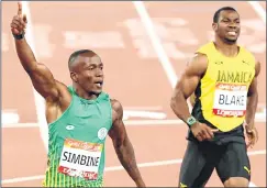  ??  ?? Akani Simbine (L) celebrates after winning the 100 meters final while Yohan Blake looks on.