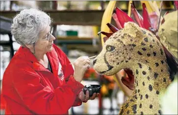  ?? Irfan Khan Los Angeles Times ?? JACQUE GIUFFRE, 69, who says her first Rose Parade job was as a welder on large animal floats in 1974, does detail work on a cheetah on “Sharing Nature’s Bounty,” Dole Packaged Foods’ entry in this year’s parade.