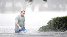  ?? MATT BORN/THE STAR-NEWS VIA AP ?? Jake Head walks through heavy rain from Tropical Storm Florence on Saturday in Wilmington, North Carolina.