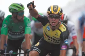  ?? AP PHOTO BY CHRISTOPHE ENA ?? Netherland­s’ Dylan Groenewege­n celebrates as he crosses the finish line to win the seventh stage of the Tour de France cycling race over 230 kilometers (142,9 miles) with start in Belfort and finish in Chalon sur Saone, France on Friday.