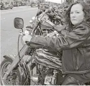  ?? John Carl D’Annibale / Times Union ?? Mary Rose parks her Harley-Davidson Sportster in Lake George Village, NY. The U.S. has dropped part of a settlement with Harley-Davidson.