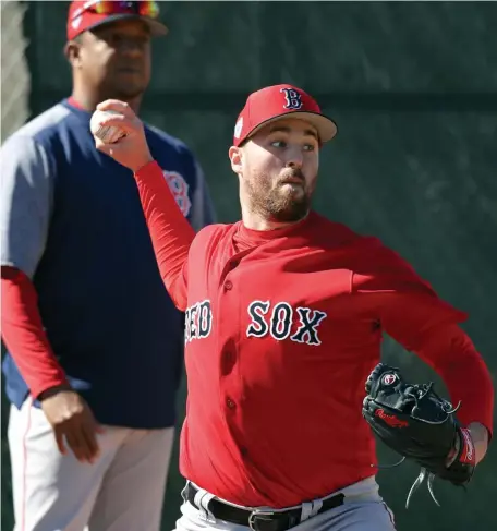  ?? CHRISTOPHE­R EVANS / BOSTON HERALD ?? LET IT RIP: Red Sox reliever Heath Hembree, who figures to play a critical role in the bullpen this season, delivers a pitch under the watch of Pedro Martinez yesterday in Fort Myers.