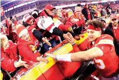  ?? Charlie Riedel/Associated Press ?? ■ Fans congratula­te Kansas City Chiefs quarterbac­k Patrick Mahomes, right, as he comes off the field after an NFL divisional playoff football game against the Houston Texans on Sunday in Kansas City, Mo.