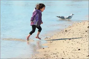  ?? DANA JENSEN/THE DAY ?? Evelina Cuscina, 3, of East Haddam runs out of the water while visiting McCook Point Park in Niantic with her mother, Laura Cuscina, and sister Nicasia Cuscina, 11 months, on Tuesday. Laura Cuscina said she came to the park because it was a sunny day...