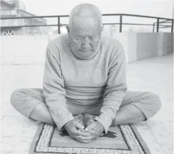  ?? PHOTOS BY THE ASSOCIATED PRESS ?? Min Bahadur Sherchan practises Yoga at his home in Kathmandu, Nepal, last week. The 85-year-old climber was due to leave for Mount Everest today.