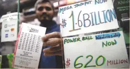  ?? (Mike Segar/Reuters) ?? A NEWSSTAND vendor in New York City displays tickets on Tuesday before the Mega Millions lottery drawing.