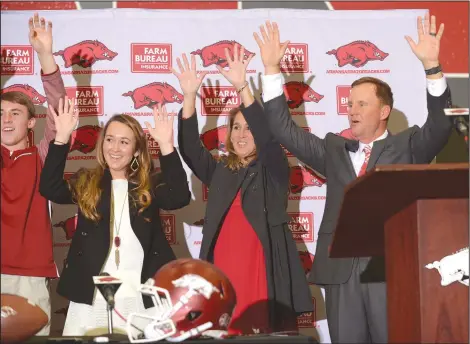  ?? NWA Democrat-Gazette/ANDY SHUPE ?? Newly hired University of Arkansas football coach Chad Morris (from right) leads a Hog Call on Thursday alongside his wife, Paula; daughter, Mackenzie; and son, Chandler during a press conference at the Fowler Family Baseball and Track Indoor Training...