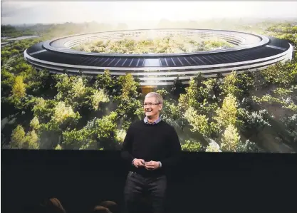  ?? KARL MONDON — STAFF ARCHIVES ?? Apple CEO Tim Cook speaks in front of a rendering of the company’s new “spaceship” headquarte­rs, which may have cost $5 billion to build.