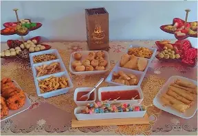  ?? ?? Variety of sweets and food for Eid celebratio­ns