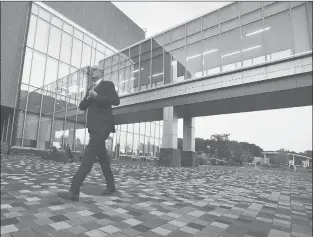  ?? BRAD HORRIGAN | BHORRIGAN@COURANT.COM ?? VAN PELT walks across the ESPN campus to dinner before a production meeting. Van Pelt says he wasn’t enamored with Connecticu­t as a bachelor, but as a dad and husband, the 52-year-old broadcaste­r has found a place he adores.