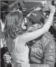  ?? AP/MICHAEL CONROY ?? Scott Dixon celebrates with his wife, Emma, after winning the pole for Sunday’s Indianapol­is 500. A few hours later, Dixon was robbed at gunpoint by two teenagers at a nearby Taco Bell.