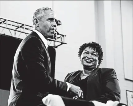  ?? JESSICA MCGOWAN/GETTY ?? Former President Barack Obama greets Georgia Democratic gubernator­ial candidate Stacey Abrams during a rally.