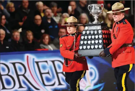  ?? The Canadian Press ?? Mounties carry the Brier Tankard during the 2020 Canadian men’s curling championsh­ip between Team Alberta and Team Newfoundla­nd in Kingston, Ont., on March 8. Curling Canada said Friday it’s increasing­ly likely Kelowna will not host the 2021 Brier.