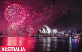  ??  ?? Rain and shine: Sydney was lit up by fireworks but drenched AUSTRALIA