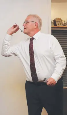  ?? Picture: Brendan Radke ?? Prime Minister Scott Morrison plays a game of darts at the Cairns and District Darts Associatio­n Hall on his visit to the Far North.