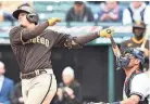  ?? KEN BLAZE/USA TODAY SPORTS ?? Padres third baseman Manny Machado hits a home run during the first game of a doublehead­er against the Guardians Wednesday in Cleveland.