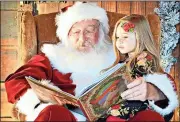  ?? Contribute­d photo ?? Cianna Stewart, the daughter of Sky Stewart, reads a book with “Santa” Ronnie Worthingto­n.