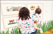  ??  ?? In this March 30, 2016 photo, visitors look at collages by children’s book author and illustrato­r Eric Carle at the High Museum of Art in Atlanta. The exhibition ‘I See a Story: The Art of Eric Carle’ opens April 2, and runs thru April 8. (AP)