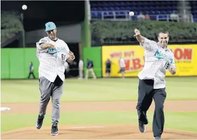  ?? LYNNE SLADKY/AP ?? Former Florida Marlins players Livan Hernandez, left, and Mike Lowell, right, throw ceremonial pitches before Sunday’s game, capping the 25th anniversar­y weekend at Marlins Park.