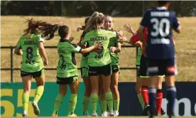  ?? Photograph: Mike Owen/Getty Images ?? Canberra United’s Nicki Flannery is mobbed after scoring against Melbourne Victory at Epping Stadium.