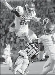  ?? Arkansas Democrat-Gazette file photo ?? Arkansas wide receiver Drew Morgan hurdles Mississipp­i defensive back Cameron Ordway during the fourth quarter. Morgan finished with 9 catches for 122 yards and 3 touchdowns, including a game-tying 9-yard score in overtime in the Razorbacks’ victory.