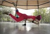  ?? AP file photo ?? Carlos Cruz, a breakdance­r, practices at a kiosk in Mexico City in August.