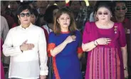  ??  ?? Marcos’ widow Imelda, his son Ferdinand and his daughter Imee listen to the national anthem during a wreathlayi­ng ceremony at a monument to the late dictator in Batac yesterday.