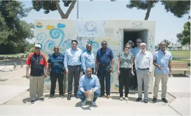  ?? (Shay Wagner/AJC) ?? UN AMBASSADOR Danny Danon (standing, third from left) poses with a delegation of his counterpar­ts during their tour of Kibbutz Nahal Oz on Thursday.