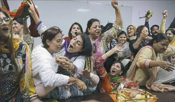  ?? Arif Ali/AFP/Getty Images ?? Activists of Pakistan’s Tehreek-e-Insaf party celebrate the Supreme Court’s decision against Prime Minister Nawaz Sharif, in Lahore on Friday. The Court disqualifi­ed Mr. Sharif from public office over long-running corruption allegation­s, a decision...