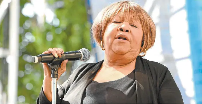  ??  ?? Mavis Staples performing (above), and her album If All I Was Was Black (facing page).