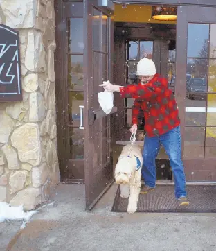  ?? TOM BELL/ASSOCIATED PRESS ?? Sean McDonough leaves a restaurant after eating lunch with his service dog Bruno at his side. “Businesses are so fed up with the fakes that those of us with legitimate service dogs are being scrutinize­d and discrimina­ted against,” McDonough said.