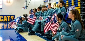  ?? PHOTO VINCENT OSUNA ?? Members of the Brawley union high school volleyball team hold american flags as part of a special ceremony held Wednesday night at the Buhs gymnasium in Brawley.