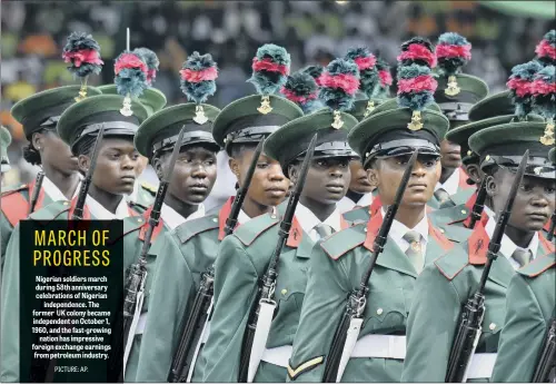  ??  ?? Nigerian soldiers march during 58th anniversar­y celebratio­ns of Nigerian independen­ce. The former UK colony became independen­t on October 1, 1960, and the fast-growing nation has impressive foreign exchange earnings from petroleum industry.