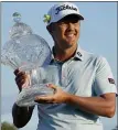  ?? MARTA LAVANDIER — AP ?? Matt Jones holds the trophy after winning the Honda Classic Sunday.