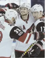  ?? AP PHOTO ?? COMING TOGETHER: Radim Vrbata (center) celebrates his go-ahead goal with Coyotes teammates in last night’s victory vs. the Lightning.