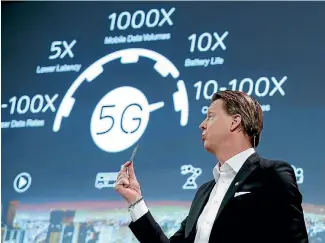  ?? PHOTO: REUTERS ?? Ericsson chief executive Hans Vestberg shows a 5G chip at the Mobile World Congress in Barcelona.