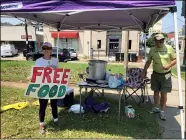  ?? KEVIN MCGILL — THE ASSOCIATED PRESS ?? Joyce and Dave Thomas offer free jambalaya, cooked by one of their neighbors, along the Carrollton streetcar tracks Sept. 2 in New Orleans