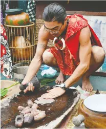  ??  ?? “Uncle” Greg Pilipo shows guests of Uncruise Adventures how to make poi, a staple Hawaiian dish of taro root, in Molokai’s Halawa Valley.